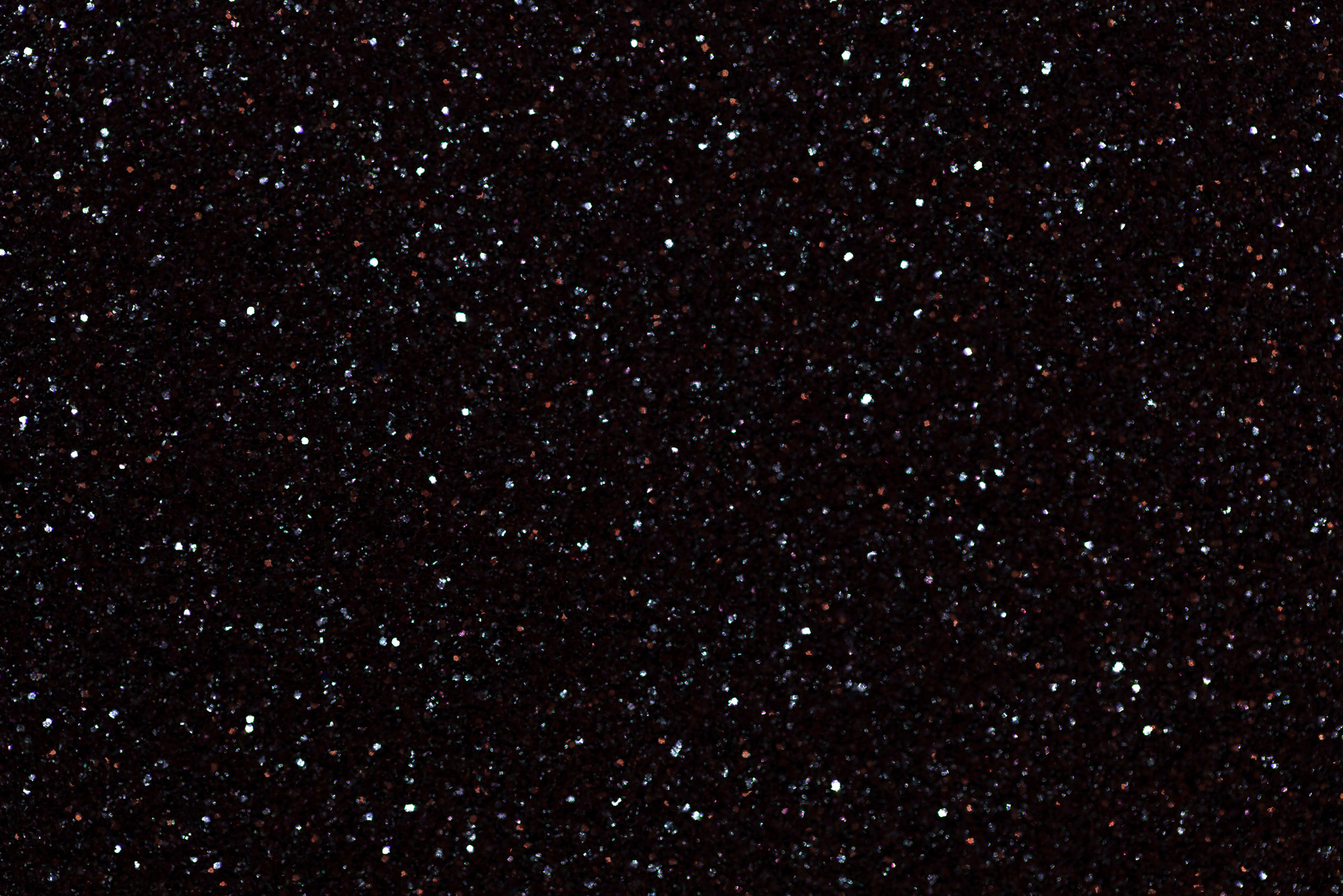 Blurred shiny black background with sparkling lights.